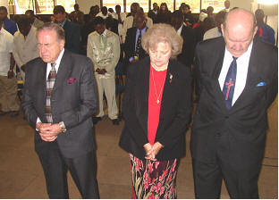 Harley Fiddler, Marge and Tony Abram stand together as the people prayed for them